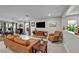 Open-concept living room featuring neutral paint, wood-look floors, and contemporary furnishings at 8346 Vinamala Ave, Las Vegas, NV 89149
