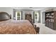 Spacious main bedroom features a large bed, bookshelves, and bright natural light at 8346 Vinamala Ave, Las Vegas, NV 89149
