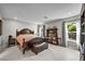 Spacious main bedroom features a large bed, bookshelves, and bright natural light at 8346 Vinamala Ave, Las Vegas, NV 89149