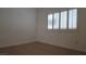 Bedroom featuring a window with white shutters and neutral carpet at 8725 W Flamingo Rd # 216, Las Vegas, NV 89147