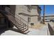 Condominium building exterior with stairs and walkway surrounded by desert landscaping on a sunny day at 8725 W Flamingo Rd # 216, Las Vegas, NV 89147