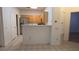 Eat-in kitchen with stainless steel refrigerator and light wood cabinets at 8725 W Flamingo Rd # 216, Las Vegas, NV 89147