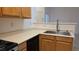 Kitchen showcasing stainless steel sink, light wood cabinets, and black dishwasher set on tiled flooring at 8725 W Flamingo Rd # 216, Las Vegas, NV 89147