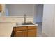 Stainless steel kitchen sink with modern faucet and light wood cabinets set on tiled flooring at 8725 W Flamingo Rd # 216, Las Vegas, NV 89147