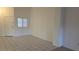 Open living space with tiled floors, a window with blinds, and access to the front door at 8725 W Flamingo Rd # 216, Las Vegas, NV 89147