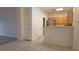 Open living area with tile and carpet flooring, connecting kitchen and living room at 8725 W Flamingo Rd # 216, Las Vegas, NV 89147