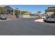 Community parking lot with a view of garages and apartments in the background at 8725 W Flamingo Rd # 216, Las Vegas, NV 89147