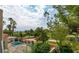 Scenic view of the backyard oasis, pool, golf course, and mature trees at 9001 Opus Dr, Las Vegas, NV 89117