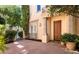 Charming front entrance with custom wood door and manicured landscaping at 9001 Opus Dr, Las Vegas, NV 89117