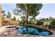 Backyard pool and hot tub surrounded by lush landscaping, perfect for outdoor relaxation at 9001 Opus Dr, Las Vegas, NV 89117