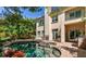 Beautiful backyard pool and spa with stone patio and stucco house at 9001 Opus Dr, Las Vegas, NV 89117