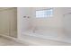 Bright bathroom with a soaking tub and glass-enclosed shower at 9236 Whitekirk Pl, Las Vegas, NV 89145