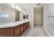 Bathroom with double sink vanity, soaking tub, and glass shower at 9236 Whitekirk Pl, Las Vegas, NV 89145