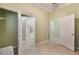Bedroom boasts tile floors, neutral walls, and entry to the en-suite bathroom at 9236 Whitekirk Pl, Las Vegas, NV 89145