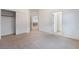 Spacious carpeted bedroom with attached closet and view into the hallway at 9236 Whitekirk Pl, Las Vegas, NV 89145