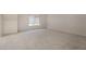 Empty bedroom with carpet flooring, window, and electrical outlets at 9236 Whitekirk Pl, Las Vegas, NV 89145