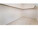 Spacious walk-in closet with rod for hanging clothes and carpeted flooring at 9236 Whitekirk Pl, Las Vegas, NV 89145