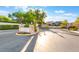 A beautiful community entrance with lush landscaping and a secure gate at 9236 Whitekirk Pl, Las Vegas, NV 89145