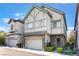 Two-story home featuring a stone-accented facade, attached two-car garage, and neat front yard landscaping at 9236 Whitekirk Pl, Las Vegas, NV 89145