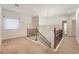 Upstairs hallway with carpeted flooring, overhead light fixture and wrought iron railing at 9236 Whitekirk Pl, Las Vegas, NV 89145