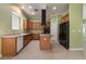 The kitchen features ample cabinetry, tile floors, and a modern island with gas cooktop at 9236 Whitekirk Pl, Las Vegas, NV 89145
