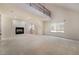 Bright living room featuring a fireplace, high ceilings, and staircase to the second floor at 9236 Whitekirk Pl, Las Vegas, NV 89145