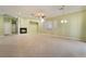 Open-concept living room with tile floors, a fireplace, and large windows for ample natural light at 9236 Whitekirk Pl, Las Vegas, NV 89145