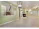 Spacious open-plan living area featuring tiled floors, a decorative fireplace, and a staircase at 9236 Whitekirk Pl, Las Vegas, NV 89145