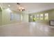 Bright, open living room with tile flooring, recessed lighting, and access to an outdoor patio at 9236 Whitekirk Pl, Las Vegas, NV 89145