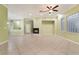 Bright living room with tile flooring, inset fireplace, and decorative glass block window for natural light at 9236 Whitekirk Pl, Las Vegas, NV 89145