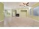 Bright living room with tile flooring, inset fireplace, and decorative glass block window for natural light at 9236 Whitekirk Pl, Las Vegas, NV 89145