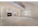 Bright living room featuring a fireplace, high ceilings, and staircase to the second floor at 9236 Whitekirk Pl, Las Vegas, NV 89145