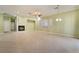 Expansive living room features a modern fireplace, decorative windows, and neutral-toned tile flooring at 9236 Whitekirk Pl, Las Vegas, NV 89145