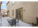 A cozy patio with a metal table and chairs for outdoor relaxation and dining at 9236 Whitekirk Pl, Las Vegas, NV 89145