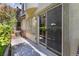 Covered patio with privacy landscaping, and glass sliding door at 9236 Whitekirk Pl, Las Vegas, NV 89145