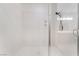 Bright, newly renovated, all-white shower with glass doors and updated fixtures at 9236 Whitekirk Pl, Las Vegas, NV 89145