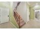 Spacious entryway featuring a staircase with carpeted steps and decorative wood railing at 9236 Whitekirk Pl, Las Vegas, NV 89145