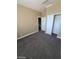 Carpeted bedroom with closet, entry door and access to stairs at 9622 Staff Ln, Las Vegas, NV 89178