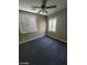 This carpeted bedroom has a ceiling fan and two windows with white blinds at 9622 Staff Ln, Las Vegas, NV 89178