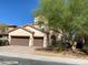 Stunning home showcasing a tile roof, stucco facade, and a large two-car garage at 9622 Staff Ln, Las Vegas, NV 89178