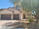 Two story home with a tile roof, two car garage, and a low-maintenance desert landscape at 9622 Staff Ln, Las Vegas, NV 89178