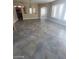 Open-concept living room featuring ceramic tile flooring and arched doorways at 9622 Staff Ln, Las Vegas, NV 89178