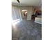 Bright living room with ceramic tile flooring leading to the kitchen and stairs at 9622 Staff Ln, Las Vegas, NV 89178