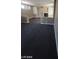 Spacious living room with fireplace, built-ins, dark carpet, and bright windows with shutters at 9622 Staff Ln, Las Vegas, NV 89178