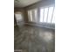 Bright living room featuring tile flooring and windows with shutters at 9622 Staff Ln, Las Vegas, NV 89178
