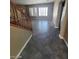 Spacious living room with stairs, tile flooring, and natural light at 9622 Staff Ln, Las Vegas, NV 89178