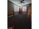Upper loft area featuring windows, cabinets, built-in shelves, and dark gray carpet at 9622 Staff Ln, Las Vegas, NV 89178