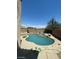 Inviting backyard pool with attached spa, surrounded by a spacious patio and privacy wall at 9622 Staff Ln, Las Vegas, NV 89178
