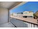 Second-story balcony with wrought iron railing, and view of the backyard, fence and neighborhood at , Henderson, NV 89011