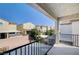 Balcony view of neighboring houses, trees, brick walls, and blue sky at , Henderson, NV 89011